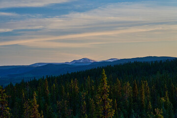 sunset over Nordic wilderness with endless boreal forest.