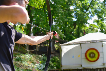 Man aiming at target archery training