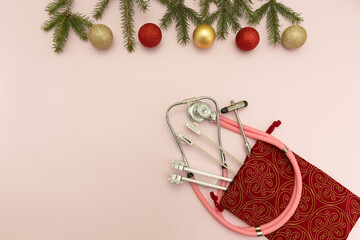 Christmas Medical Instruments with Christmas Tree and red and gold balls on pink Background. New...