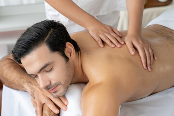 Caucasian man customer enjoying relaxing anti-stress spa massage and pampering with beauty skin...