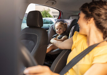 Mother driving while child is safely seated in car seat