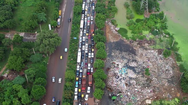 Aerial drone shot panning up revealing kilometres of traffic jam due to flooded, broken and damaged roads on southern peripheral road gurgaon dwarka expressway showing bad infrastructure