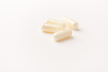 Creatine tablets on paper background. Soft focus. Close up. Copy space.	