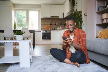 Young Woman Using Smartphone at Home, Relaxing on the Floor