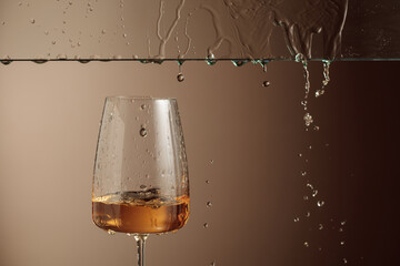 White wine flows down into a glass.