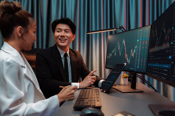 Businessman holding tablet on dynamic stock exchange statistic online showing to partners to share,...