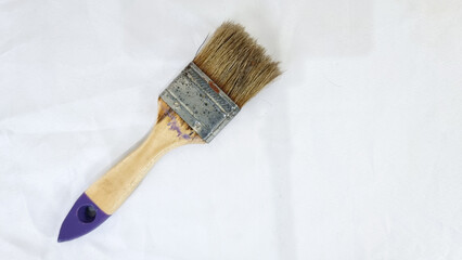Used paint brush isolated on white background. Wooden handle paint brush.