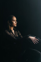 A mysterious woman stands in silhouette against a bright window, surrounded by dramatic smoke and...