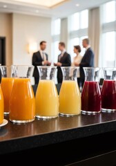 Fresh juice carafes on counter at business event.