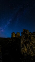 Ancient towers under a starlit night sky