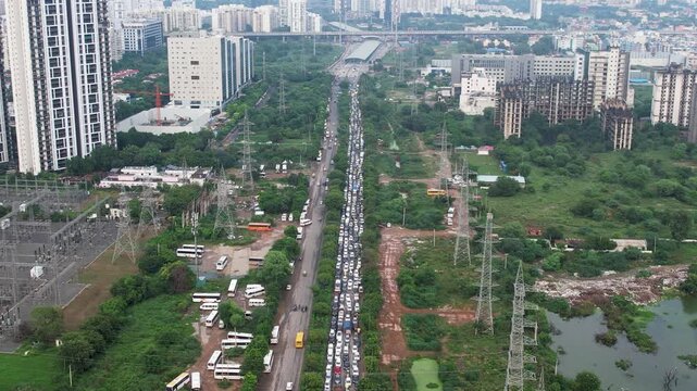 Aerial drone shot flying back revealing kilometres of traffic jam due to flooded, broken and damaged roads on southern peripheral road gurgaon dwarka expressway showing bad infrastructure