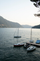Sailing boat at the dock overlooking Lake Como Italy
