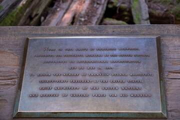 Close-up of historical plaque with engraved text at Muir Woods National Monument, CA on April 16, 2023