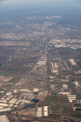 Aerial urban sprawl extending toward distant horizon under clear skies, February 6, 2023
