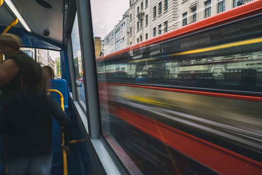 View of a red british Bus moving in London from inside another bus