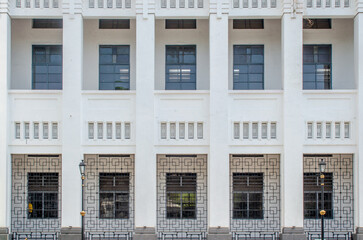 Fototapeta premium This photo captures the facade of a building showcasing architectural symmetry and design, meticulous detail, highlights the interplay of light and shadow.