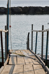 Weathered wooden pier with metal railings