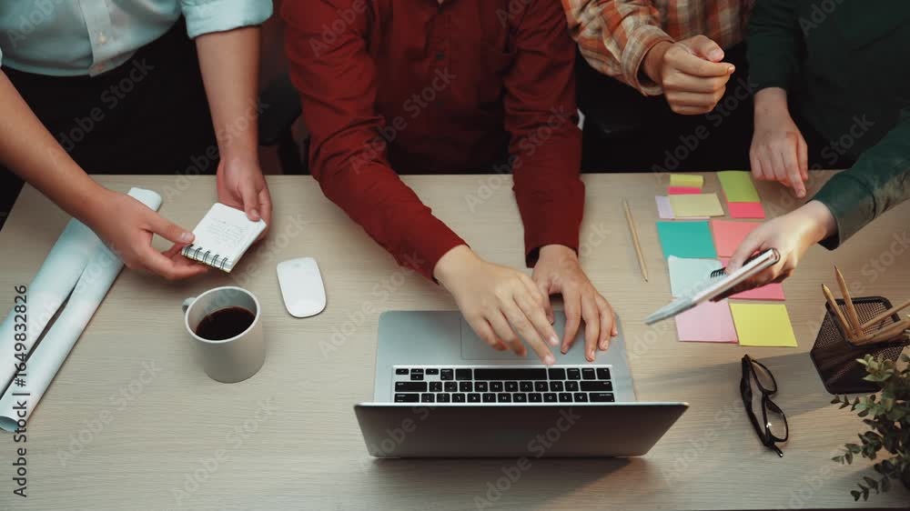 Poster a dynamic scene of a team collaborating in a modern office. individuals are engaging over a laptop w