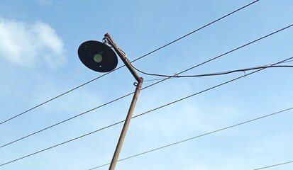 Obraz premium The lamp post is a source of lighting with electrical cables around it. 