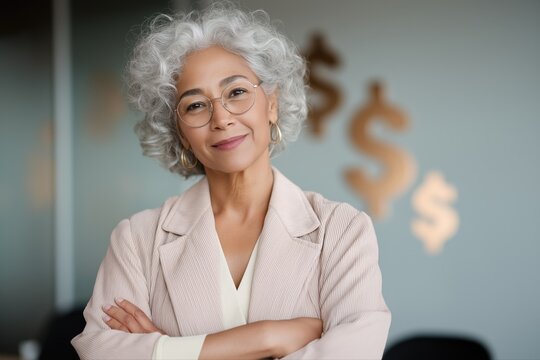 Confident mature asian female entrepreneur in office with financial symbols - Powered by Adobe