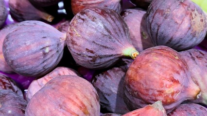 Ripe purple figs with a natural texture — an authentic fruit backdrop for culinary design,...