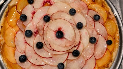 Homemade fruit tart with peaches, apples, and blueberries — an appetizing composition for...