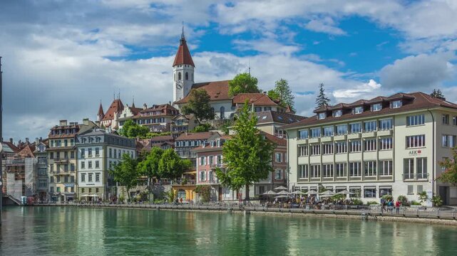 Time lapse, old European town with church and river. City Church, Aare river, Thun, canton of Bern, Switzerland.