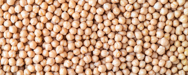 Chickpeas are piled closely together, creating a textured surface. Nutritious food ingredient, healthy legume