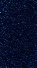 Fototapeta premium Abstract pattern of numerous dark blue water droplets on a surface, macro detail