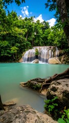 Naklejka premium Lush waterfall cascading into turquoise pool