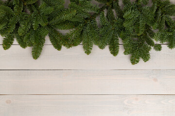 Christmas tree branches on wooden background, top view
