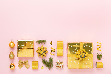 Handmade wrapped christmas gift boxes with stuff on color background, top view