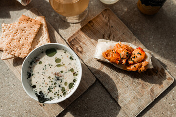 Maine clam chowder, clams, lobster, oysters plated at a restaurant with gorgeous light