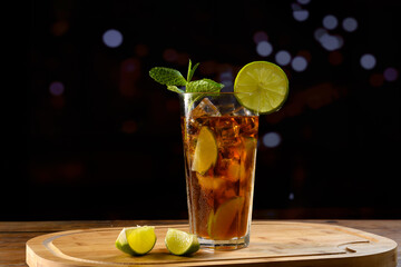 Refreshing Cuba Libre cocktail with lemon and mint garnish