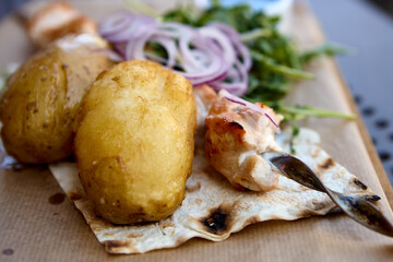 Serving of potatoes with grilled chicken