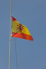 Spanish flag waving in the wind on a sunny day