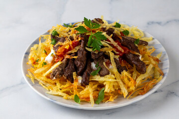 Turkish food; Cokertme Kebab - Beef meat kebab with yoghurt and french fries