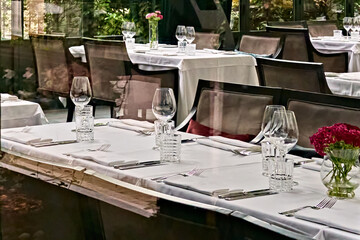 Elegant empty restaurant dining room with set tables