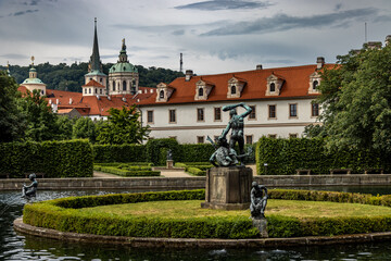 A garden and water fountain in the old town of Prague.
