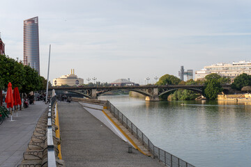 Seville's Waterfront Bridge: Captured from the riverbank, this photo showcases the bridge's elegant...