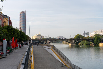 Urban Bridge Over River: A serene cityscape unfolds, with a sturdy bridge arching over a calm...