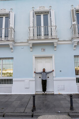 Urban Facade and Person: A person poses confidently in front of a beautifully designed urban...