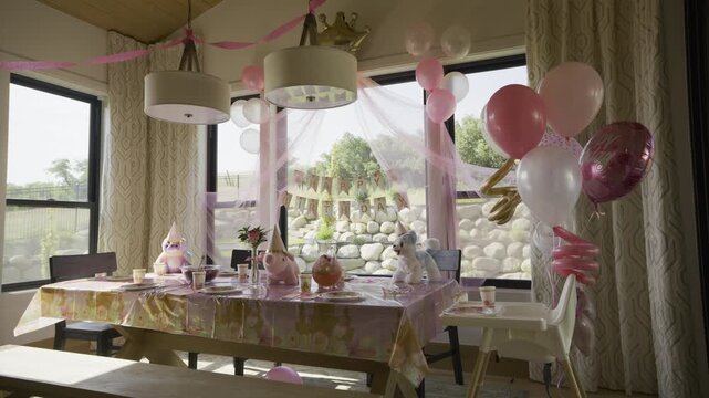 Pink theme birthday party for little girl set up in kitchen - wide shot