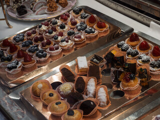 Assorted Gourmet Pastries Displayed on Silver Trays