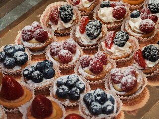 Delicious Mini Fruit Tarts with Cream and Berries
