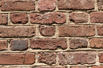 Weathered Brick Wall Texture. Close-up of weathered plantation bricks with visible slave fingerprints, showcasing unique texture and history.