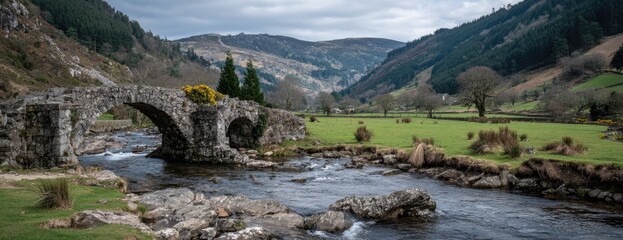Ancient stone arch bridge over a rushing stream, nestled in a valley surrounded by hills and lush greenery