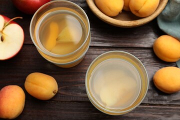 Tasty compot and fruits on wooden table, flat lay
