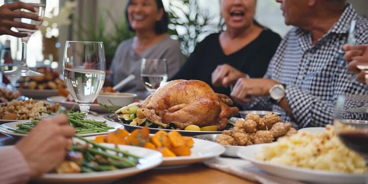 Friendsgiving with friends having a traditional thanksgiving turkey dinner