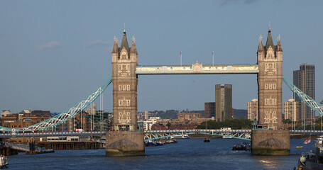 Fototapeta premium Tower Bridge, an iconic symbol of London, basking in the afternoon sunlight with the cityscape in the background